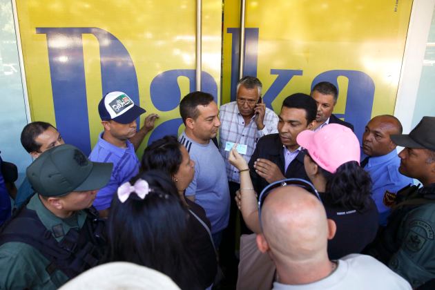 Shoppers crowd outside a Daka store as they wait to shop for electronic goods in Caracas