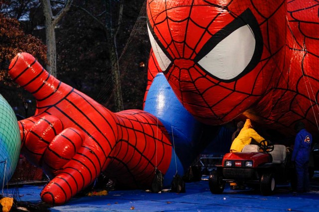 Members of the Macy's Thanksgiving Day Parade balloon inflation team work in Spiderman during preparations for the 88th annual Macy's Thanksgiving Day Parade in New York