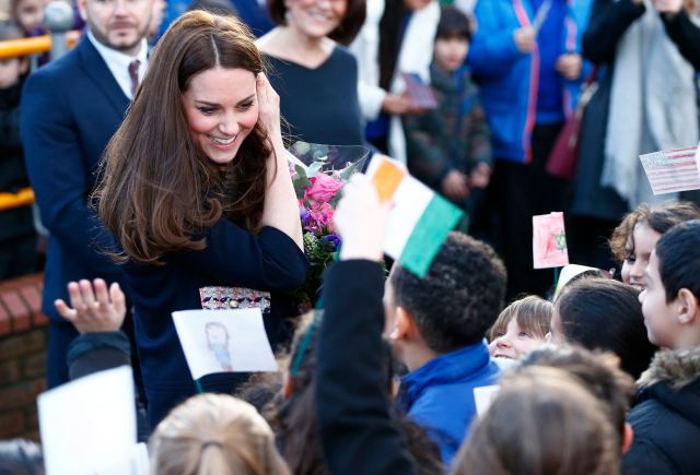 Britain's Catherine, Duchess of Cambridge speaks to school children as she leaves after visiting the Clore Art Room in west London