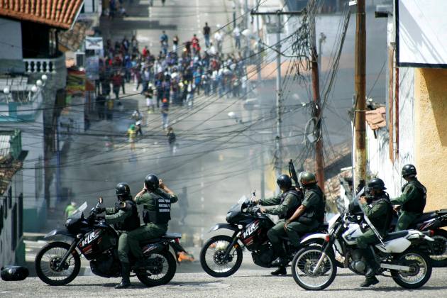 Students clash with national guards during a protest against the government in San Cristobal