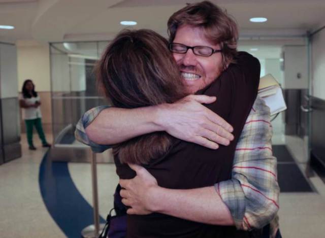 Original Caption: Colleague Luisa Yanez, left, gives Jim Wyss, a welcome hug upon his arrival. Miami Herald reporter Jim Wyss arrived at Miami International Airport after being detained by Venezuela for three days on Sunday, November 10, 2013. MIAMI HERALD STAFF