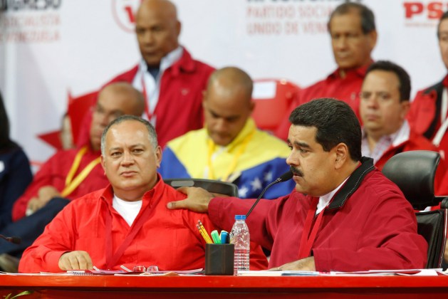 Venezuela's President Nicolas Maduro talks next to National Assembly President Diosdado Cabello at a meeting of the United Socialist Party in Caracas