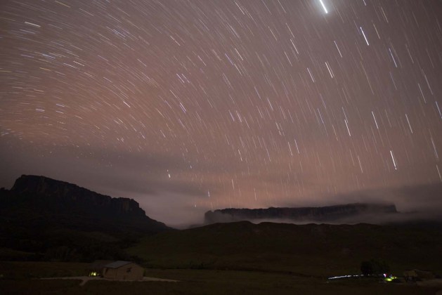 Stars are seen in the night sky over Kukenan and Roraima mounts near the Tec Camp, near Venezuela's border with Brazil