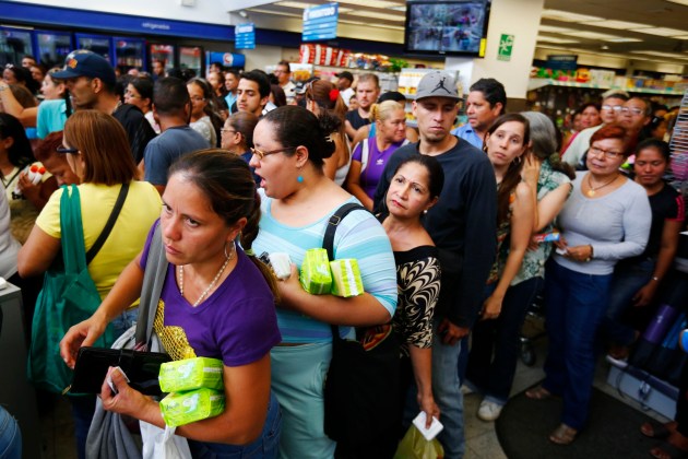 People queue up to pay at a Farmatodo drugstore in Caracas