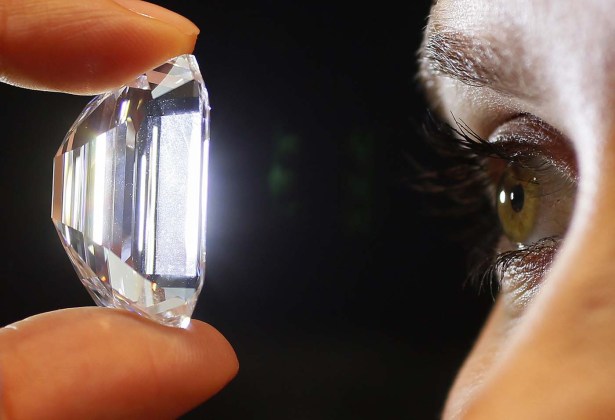 A staff member holds a 100-carat perfect diamond in a classic emerald-cut at Sotheby's auction house in central London