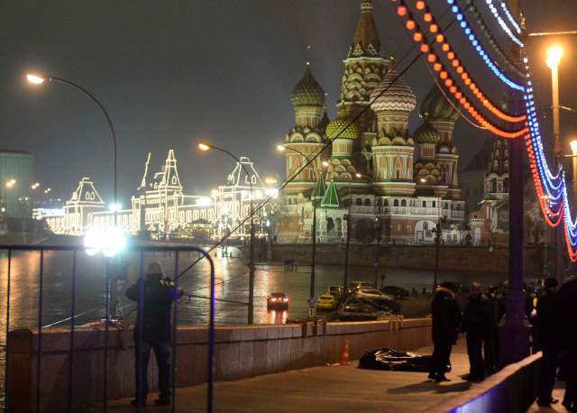 A view shows the covered body of Boris Nemtsov, with St. Basil's Cathedral seen in the background, in central Moscow