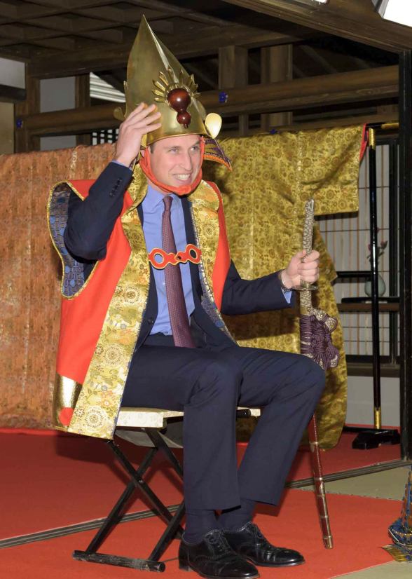 Handout photo shows Britain's Prince William trying on a samurai costume during his visit a Taiga historical drama studio set at NHK in Tokyo