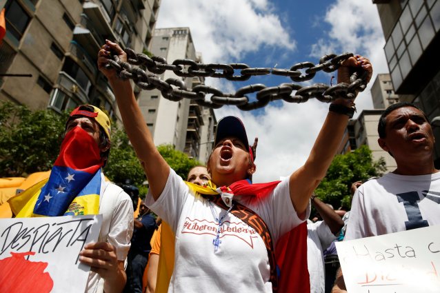 Opposition supporters shout during a gathering to protest against Venezuelan government and in support of jailed leaders Leopoldo Lopez and Antonio Ledezma in Caracas