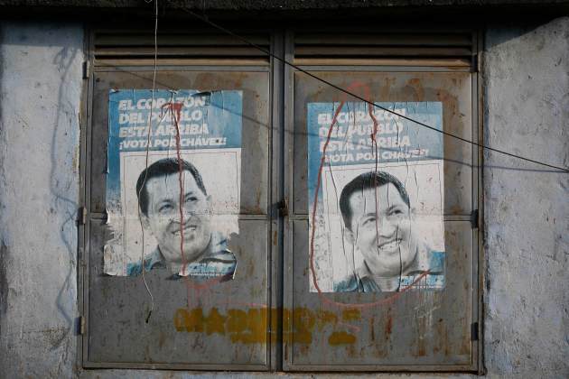 Posters with pictures of Venezuela's late President Hugo Chavez are seen on doors in Caracas