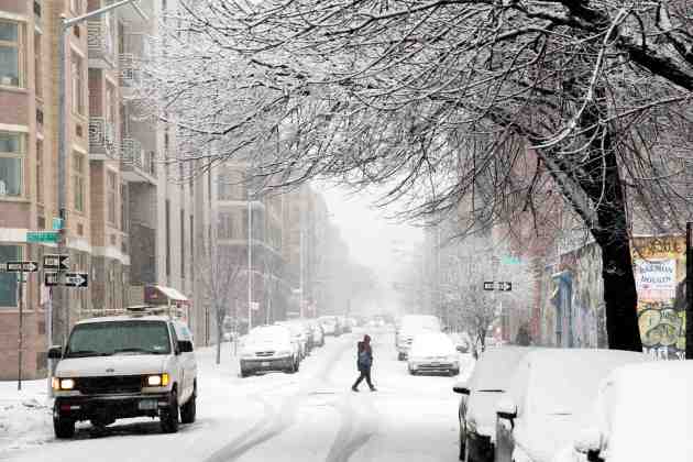 A pedestrian walks through a snow storm in New York