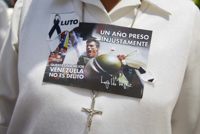 A flyer with a picture of jailed opposition leader, Lopez, on the chest of a woman during a rally to commemorate International Women's Day and in support of him and jailed opposition leader, Ledezma, in Caracas