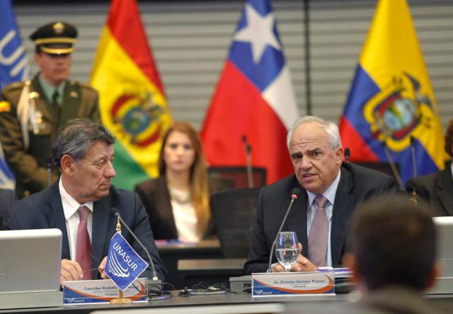 Uruguay's Foreign Minister Rodolfo Nin Novoa listens to UNASUR's Secretary-General Ernesto Samper during a meeting at the UNASUR headquarters in Quito