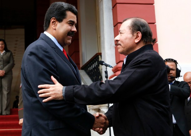 Venezuela's President Maduro and Nicaragua's President Ortega shake hands during ALBA alliance summit in Caracas