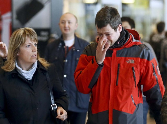 A family member of a passenger feared killed in Germanwings plane crash reacts as he arrives at Barcelona's El Prat airport