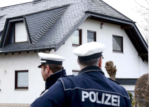 German policemen stand outside a house believed to belong to crashed Germanwings flight 4U 9524 co-pilot Lubitz in Montabaur