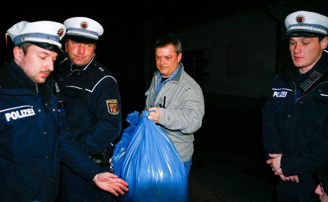 German police officers carry bags out of a house believed to belong to the parents of crashed Germanwings flight 4U 9524 co-pilot Andreas Lubitz in Montabaur