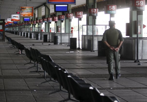 A Gendarmerie officer walks on a platform of an empty bus station during a one-day nationwide strike in Buenos Aires