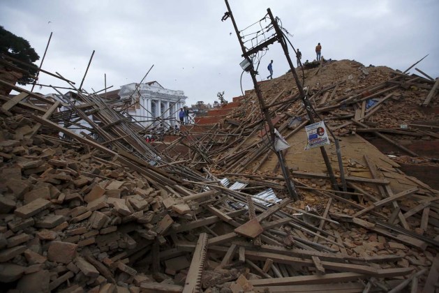 People work to rescue trapped people inside a temple in Bashantapur Durbar Square after an earthquake hit, in Kathmandu
