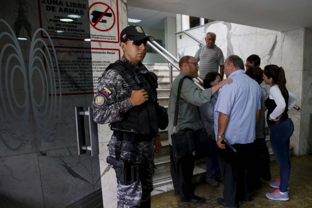 A police officer stands guard at the main entrance of the clinic where arrested Caracas metropolitan mayor Antonio Ledezma was transferred due to medical problems in Caracas
