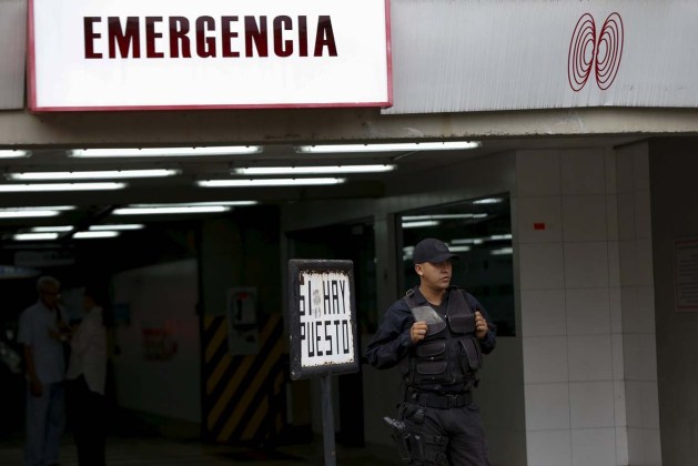 A police officer stands guard outside the clinic where arrested Caracas metropolitan mayor Antonio Ledezma was transferred due to medical problems in Caracas