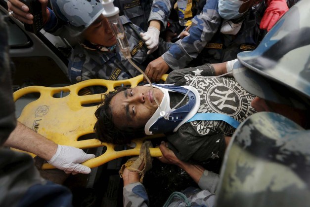 Earthquake survivor is rescued by the Armed Police Force from the collapsed Hilton Hotel, the result of an earthquake in Kathmandu