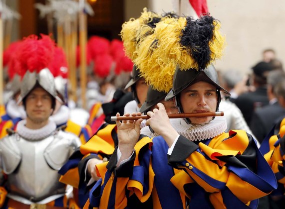 A new recruit of the Vatican's elite Swiss Guard plays an instrument as they march during the swearing-in ceremony at the Vatican
