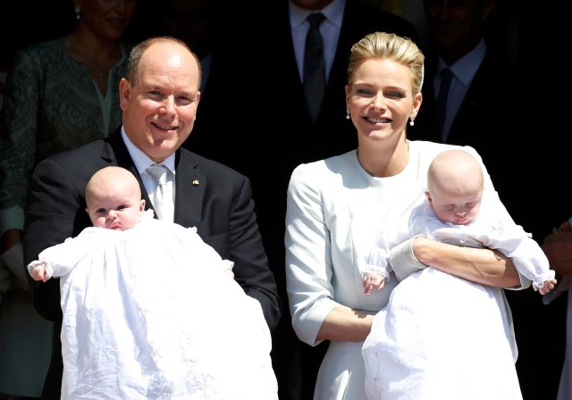 Prince Albert II of Monaco and his wife Princess Charlene hold their twins Prince Jacques and Princess Gabriella as they leave Monaco's Cathedral