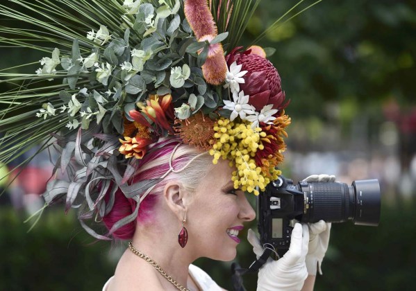 A race goer takes a photo on Ladies Day at Royal Ascot, just south of London