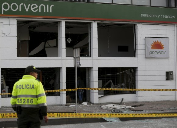 A policeman stands at the site where an explosion occurred at the office of the Porvenir pension fund in downtown Bogota