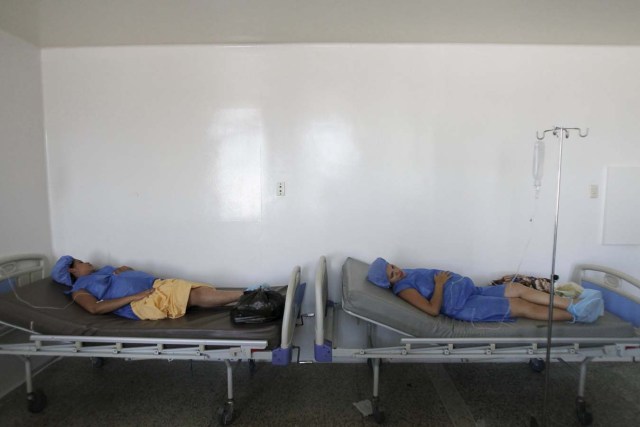 Pregnant women lay on beds without sheets during their labour at a maternity hospital in Maracaibo, Venezuela