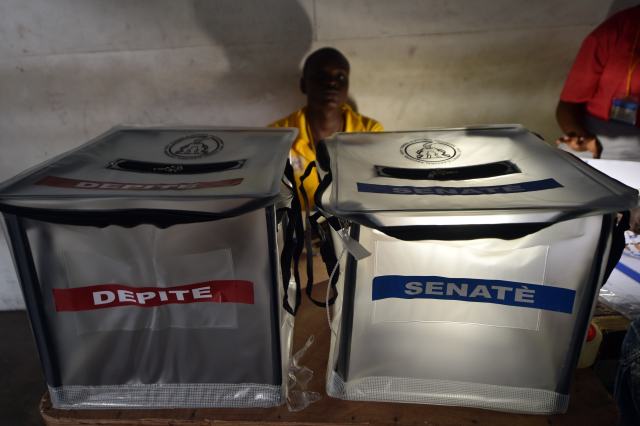 Election officials prepare the ballots for voters in Port-au-Prince, Haiti, on August 9, 2015, during the Legislatives Elections.After nearly four years of delays, Haiti staged legislative elections Sunday in a vote overshadowed by fears of violence and poor turnout. Polling stations opened at 6:00 am (1000 GMT) for the first time since President Michel Martelly came to power in May 2011. The poorest country in the Americas, Haiti suffers from a history of chronic instability and is still struggling to recover from the devastating 2010 earthquake. AFP PHOTO/HECTOR RETAMAL