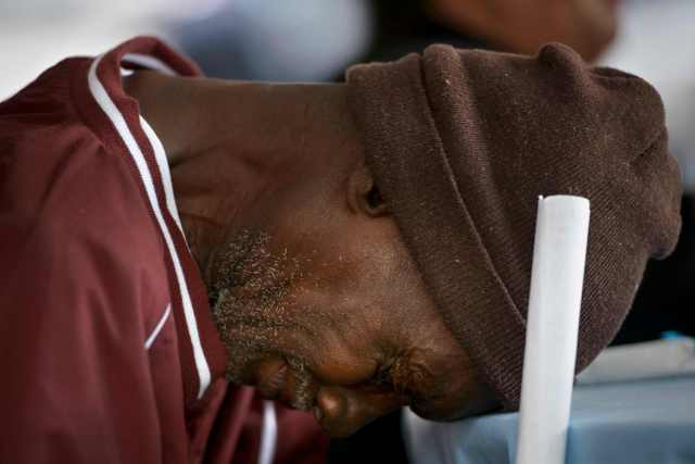 Michael White listens to hymns while waiting for Pope Francis to arrive and bless a meal outside the Catholic Charities office September 24, 2015 in Washington, DC. Pope Francis is in the United State for 6 days during his first trip as the leader of the Catholic Church. REUTERS/Brendan Smialowski/Pool