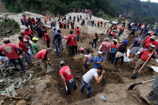 Rescue team members and volunteers search for mudslide victims in Santa Catarina Pinula