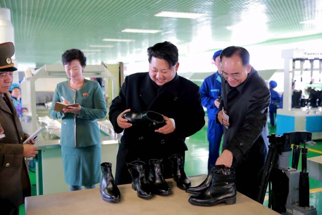 North Korean leader Kim Jong Un (2nd R) gives field guidance at the Wonsan Shoes Factory in this undated photo released by North Korea's Korean Central News Agency (KCNA) in Pyongyang November 27, 2015.    