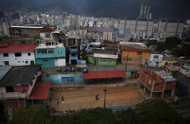 Children gather before playing softball at a slum in Caracas December 5, 2015. Venezuela will hold parliamentary elections on December 6. REUTERS/Nacho Doce