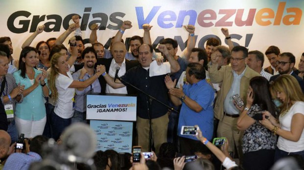 (From 3rd L to R) The wife of jailed Venezuelan opposition leader Leopoldo Lopez, Lilian Tintori, Freddy Guevara, of the Voluntad Popular party, Jesus Torrealba, head of the Democratic Unity Movement (MUD) party and deputy Julio Borges celebrate after knowing the first results of the legislative election, at the MUD headquarters in Caracas, on the early morning December 7, 2015. Venezuela's opposition won --at least--a majority of 99 out of 167 seats in the state legislature, electoral authorities said Monday, the first such shift in power in congress in 16 years.   AFP PHOTO/LUIS ROBAYO / AFP / LUIS ROBAYO