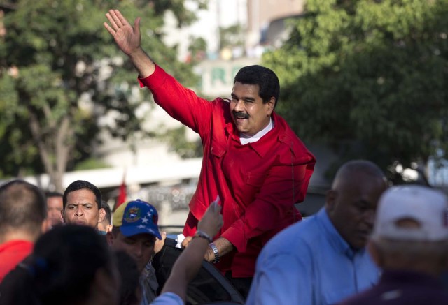 El presidente venezolano Nicolás Maduro saluda a sus partidarios durante el acto de cierre de campaña del oficialismo el 1ro de diciembre del 2015 en Caracas. Las encuestas dicen que el oficialismo podría sufrir su peor derrota electoral desde el triunfo de la revolución chasvista en las elecciones legislativas del domingo 6 de diciembre.(AP Photo/Ariana Cubillos)