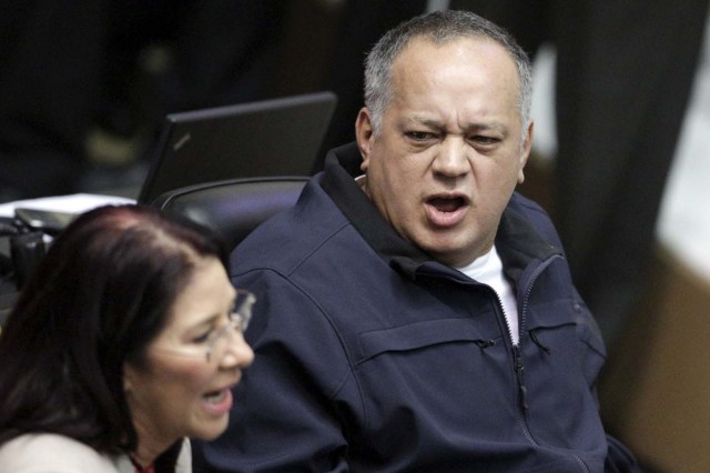 Diosdado Cabello (R), deputy of Venezuela's United Socialist Party (PSUV), talks to his fellow deputy and wife of Venezuela's President Nicolas Maduro Cilia Flores during a session of the National Assembly in Caracas January 6, 2016. Venezuela's opposition defied a court ruling and swore into the new congress on Wednesday three lawmakers barred from taking their seats, deepening the showdown between the legislature and President Nicolas Maduro's government. REUTERS/Marco Bello