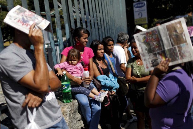 People line up to try to buy staple food and household items, outside a supermarket in Caracas January 16, 2016. Venezuela's socialist government decreed an "economic emergency" on Friday that will expand its powers and published the first data in a year that shows the depth of a recession fueled by low oil prices and a sputtering state-led model. The central bank, which has been lambasted by critics of President Nicolas Maduro's government for hiding statistics since the end of 2014, said the South American OPEC nation's economy shrank 4.5 percent in the first nine months last year. Inflation soared in that period to an annual rate of 141.5 percent, the world's worst. REUTERS/Carlos Garcia Rawlins