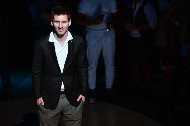 Argentinian football player Lionel Messi poses prior the Dolce & Gabbana Spring-Summer 2014 Menswear collection on June 22, 2013 during the fashion week in Milan.    AFP PHOTO / GIUSEPPE CACACEGIUSEPPE CACACE/AFP/Getty Images