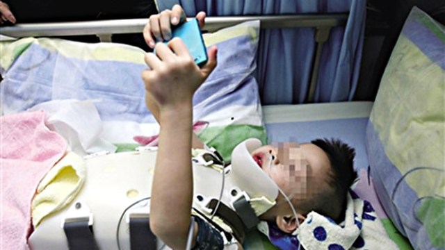 El niño pidió el teléfono para jugar tras la operación (foto SCMP)