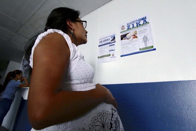 A pregnant woman reads a government campaign poster informing about Zika virus symptoms at the maternity ward of a hospital in Guatemala City, Guatemala, January 28, 2016. REUTERS/Josue Decavele