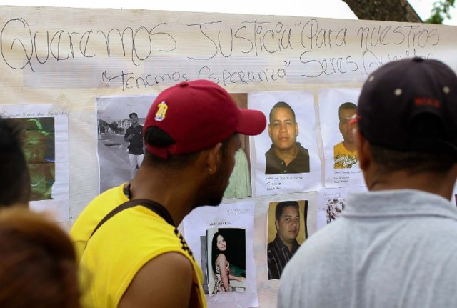 People, including relatives and friends of 28 miners who went missing last week and are feared killed in an attack, block a key highway connecting Venezuela and Brazil in the town of Tumeremo, in the Venezuelan state of Bolivar, to demand answers on what happened to their loved ones, on March 8, 2016. The miners failed to return home from work after their shifts on March 3, and stories soon began circulating that a group of gunmen had attacked the goldmine in southeastern Venezuela where they worked.   AFP PHOTO / WILLIAM URDANETA / AFP / WILLIAM URDANETA