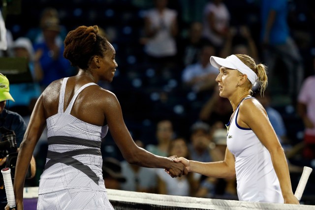 Mar 25, 2016; Key Biscayne, FL, USA; Elena Vesnina (R) shakes hands with Venus Williams (L) after their match during day four of the Miami Open at Crandon Park Tennis Center. Vesnina won 6-0, 6-7(5), 6-2. Mandatory Credit: Geoff Burke-USA TODAY Sports