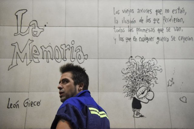Argentine writer Enrique "Kike" Ferrari is seen at a subway station in Buenos Aires, Argentina, on March 14, 2016. Ferrari is an award-winning writer who makes his living cleaning a metro station in Argentina. His noir novels were translated into four languages in six countries, and received awards in Spain and Cuba. AFP PHOTO/EITAN ABRAMOVICH / AFP / EITAN ABRAMOVICH