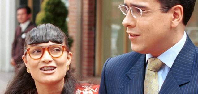 Ana Maria Orozco portrays 'Betty, la Fea,' 'the ugly one', as she walks with Jorge Enrique Abello who plays her boss 'don Armando' in Bogota, Colombia Thursday March 16, 2000. 'Betty la Fea' Colombia's highest rated soap opera is challenging viewers to examine social mores and the role physical appearances play in the beauty-conscious society . (AP Photo/Ariana Cubillos)