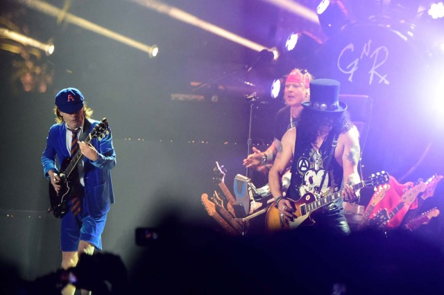 INDIO, CA - APRIL 16: (L-R) Musician Angus Young of AC/DC performs onstage with Axl Rose and Slash of Guns N' Roses during day 2 of the 2016 Coachella Valley Music & Arts Festival Weekend 1 at the Empire Polo Club on April 16, 2016 in Indio, California. Frazer Harrison/Getty Images for Coachella/AFP