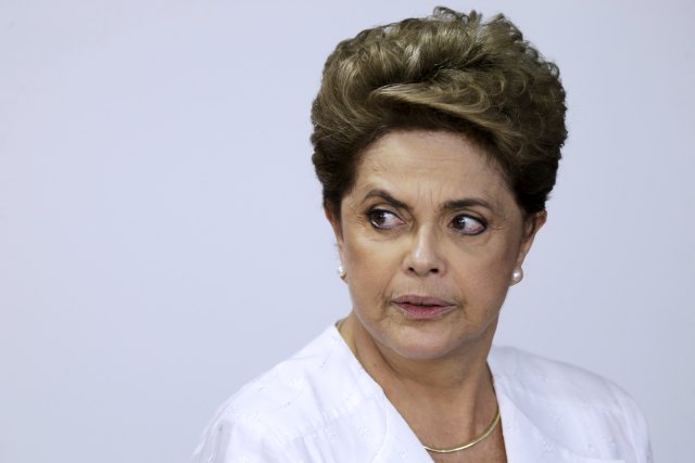 Brazil's President Dilma Rousseff looks on during signing of federal land transfer agreement for the government of the state of Amapa at Planalto Palace in Brasilia, Brazil, April 15, 2016. Rousseff lost a decisive impeachment vote in the lower house of Congress on Sunday and appeared almost certain to be forced from office in a move that would end 13 years of leftist Workers' Party rule. REUTERS/Ueslei Marcelino TPX IMAGES OF THE DAY