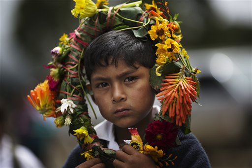 En esta imagen del martes 29 de marzo de 2016, Giusepe Morales lleva una corona de flores en la cabeza mientras espera al regreso de los restos de víctimas del conflicto en Perú entre 1980 y 2000, en Huanta, Perú. Los muertos, víctimas de rebeldes de inspiración maoísta en 1991, eran su mayoría niños y ancianos, y murieron cuando rezaban dentro de una iglesia. (AP Foto/Rodrigo Abd)