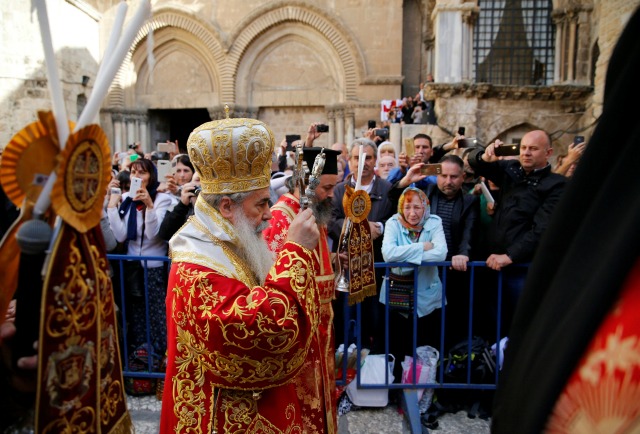 Patriarca Ortodoxo Griego de Jerusalén Teófilo Metropolitana (C) conduce el lavado de la ceremonia de los pies fuera de la Iglesia del Santo Sepulcro en la Ciudad Vieja de Jerusalén, 28 de Abril, 2016, por delante de la Pascua ortodoxa. REUTERS / Ammar Awad